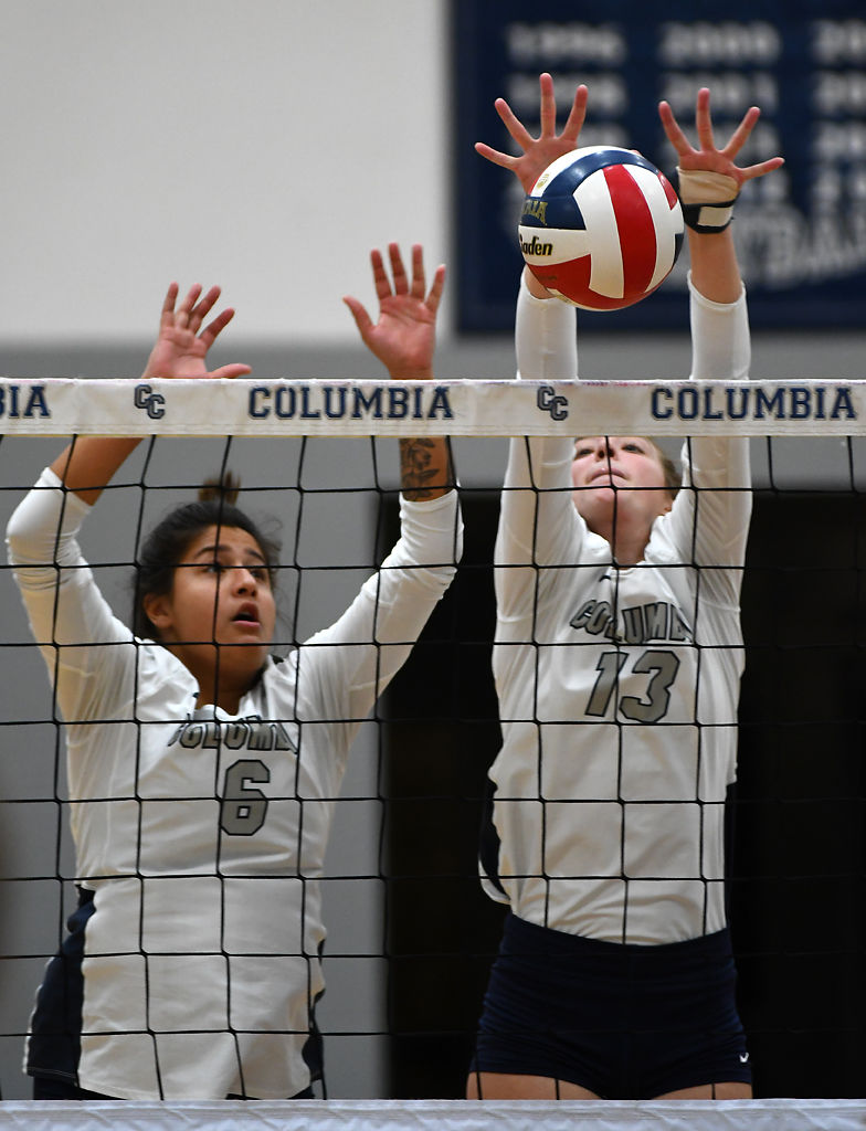 Luisa Ferreira and Bailee Ulery block a hit by Lyon College